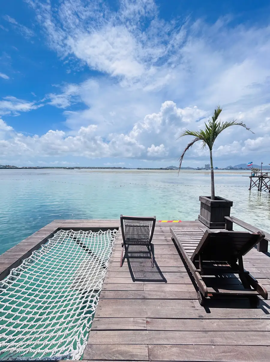 Sun-drenched balcony offering a large overwater mesh bed at Sea Coral Resort. A meditative haven near Semporna suspended between sea and sky above crystal-clear waters.